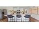 Spacious kitchen island with modern bar stools, stainless appliances, and sleek countertops at 5075 Marshelder, Apopka, FL 32712