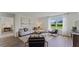 Inviting living room with neutral tones, contemporary furnishings, and a large window offering a pleasant view at 5075 Marshelder, Apopka, FL 32712