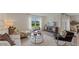 Comfortable living room featuring modern decor, plush seating, and a view of the outdoor landscape at 5075 Marshelder, Apopka, FL 32712