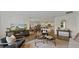 Spacious open-concept living area with stylish furniture and seamless flow into the kitchen and dining spaces at 5075 Marshelder, Apopka, FL 32712