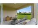 Relaxing covered patio featuring comfortable seating and a scenic view of the lawn at 5075 Marshelder, Apopka, FL 32712