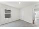 Neutral carpeted bedroom featuring a large window and entry to bathroom at 5210 Marshelder, Apopka, FL 32712