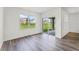 Bright bedroom featuring a sliding glass door to patio, large windows and wood-look flooring at 5210 Marshelder, Apopka, FL 32712