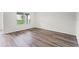 Bright bedroom featuring wood-look flooring, a large window, and a neutral color scheme at 5210 Marshelder, Apopka, FL 32712