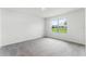 Bright bedroom featuring a large window with views of the outdoors and plush carpeting at 5210 Marshelder, Apopka, FL 32712