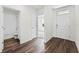 Inviting entryway with dark wood-look flooring leading to an open floor plan and bathroom at 5210 Marshelder, Apopka, FL 32712