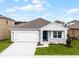Charming single-story home with a well-manicured lawn, two car garage and inviting front entrance at 5210 Marshelder, Apopka, FL 32712