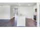 Well-lit kitchen featuring an island, stainless steel appliances, and white cabinetry at 5210 Marshelder, Apopka, FL 32712