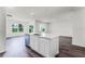 Open-concept kitchen with a center island, sink, dishwasher, and hardwood floors at 5210 Marshelder, Apopka, FL 32712
