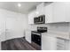 Modern kitchen features stainless steel appliances and bright white cabinets at 5210 Marshelder, Apopka, FL 32712