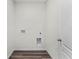 A clean laundry room featuring hookups and luxury vinyl plank flooring at 5210 Marshelder, Apopka, FL 32712