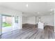 Bright living area with hardwood floors, patio access, and open-concept kitchen at 5210 Marshelder, Apopka, FL 32712