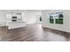 Open living area featuring hardwood floors, a kitchen island, and natural light at 5210 Marshelder, Apopka, FL 32712