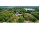 An aerial view of a home featuring a swimming pool surrounded by lush landscaping and a nearby lake at 530 Webster St, Lake Mary, FL 32746