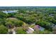 Aerial view of a home surrounded by lush trees and near a lake at 530 Webster St, Lake Mary, FL 32746