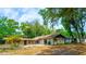 Exterior view of a home with a brick patio and lush greenery at 530 Webster St, Lake Mary, FL 32746
