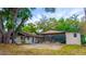 Exterior shot of a home's backyard with screened in porch and covered patio at 530 Webster St, Lake Mary, FL 32746