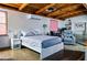 Cozy bedroom with a wood beam ceiling, tile floors, and sitting area at 530 Webster St, Lake Mary, FL 32746