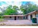 Rear of a home featuring a brick patio, covered parking area, and an expansive backyard at 530 Webster St, Lake Mary, FL 32746