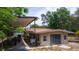 Exterior of a home featuring a covered parking area, outdoor patio space, and mature landscaping at 530 Webster St, Lake Mary, FL 32746