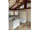 Bright kitchen with an island, stainless appliances, and wood beam ceiling at 530 Webster St, Lake Mary, FL 32746