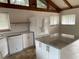 Well-lit kitchen boasts white appliances, granite countertops, and a functional island at 530 Webster St, Lake Mary, FL 32746