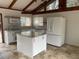 Bright kitchen features white appliances, granite countertops, and a center island at 530 Webster St, Lake Mary, FL 32746