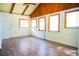 Spacious living room with wood floors, beamed ceiling, and multiple windows for ample natural light at 530 Webster St, Lake Mary, FL 32746