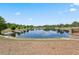 Scenic view of the community pond with trees and seating area at 611 Casa Park A Ct, Winter Springs, FL 32708