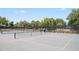 Community tennis courts with palm trees, shade and a spectator area at 611 Casa Park A Ct, Winter Springs, FL 32708