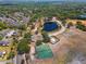 Expansive aerial shot of the community featuring basketball courts, a pond, and green spaces at 611 Casa Park A Ct, Winter Springs, FL 32708