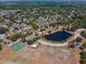 Aerial view showcasing community amenities, pond, and lush landscaping in a residential area at 611 Casa Park A Ct, Winter Springs, FL 32708