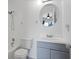 Clean bathroom featuring blue vanity, round mirror, showerhead, and tiled walls at 611 Casa Park A Ct, Winter Springs, FL 32708