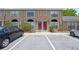 Exterior of a townhouse with red doors and well-maintained landscaping at 611 Casa Park A Ct, Winter Springs, FL 32708