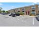 A row of townhomes with reserved parking spaces; well-kept exterior at 611 Casa Park A Ct, Winter Springs, FL 32708
