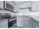 Kitchen showcasing stainless steel appliances, granite countertops, and light gray cabinetry at 611 Casa Park A Ct, Winter Springs, FL 32708