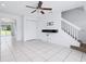 Spacious living room with tile floors, ceiling fan, and staircase leading to the upper level at 611 Casa Park A Ct, Winter Springs, FL 32708