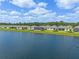 Aerial shot of waterfront community, featuring well-maintained lawns and beautiful lake views at 6121 Blue Pond Way, St Cloud, FL 34771