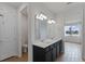 Ensuite bathroom features dual sinks, dark cabinets, and access to both a toilet and a bedroom with a lake view at 6121 Blue Pond Way, St Cloud, FL 34771