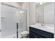 Modern bathroom with a glass-enclosed shower, white quartz countertop, and stylish navy blue vanity at 6121 Blue Pond Way, St Cloud, FL 34771