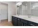 Bathroom featuring double vanity, large mirror, modern lighting fixtures, and lots of storage space at 6121 Blue Pond Way, St Cloud, FL 34771