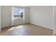 Bright bedroom with wood-style flooring and a window with scenic water views at 6121 Blue Pond Way, St Cloud, FL 34771