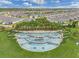 Beautiful Del Webb Sunbridge entrance featuring cascading water feature, lush landscaping and a palm tree lined median at 6121 Blue Pond Way, St Cloud, FL 34771