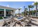 Outdoor amenity area with a gas fire pit, comfortable seating, and lush landscaping at 6121 Blue Pond Way, St Cloud, FL 34771