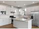 Bright kitchen with white cabinetry, stainless steel appliances, and granite countertops at 6121 Blue Pond Way, St Cloud, FL 34771