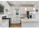 Modern kitchen featuring stainless steel appliances, white cabinets, and a center island at 6121 Blue Pond Way, St Cloud, FL 34771