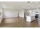 Bright living room and kitchen area features tile floors, recessed lighting and a kitchen island with white cabinets at 6121 Blue Pond Way, St Cloud, FL 34771