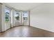 Bright living room featuring wood-style flooring and a series of windows with neighborhood views at 6121 Blue Pond Way, St Cloud, FL 34771