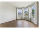 Sunlit living room with wood-style floors and many bright windows showing scenic neighborhood views at 6121 Blue Pond Way, St Cloud, FL 34771