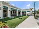 Outdoor amenity space with artificial turf, tables, chairs, corn hole, and beautiful landscaping at 6121 Blue Pond Way, St Cloud, FL 34771